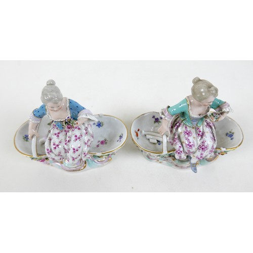 106 - A group of four 19th century Meissen salts, modelled as figures in 18th century attire sitting on tw... 