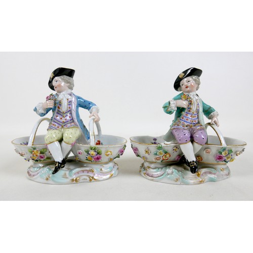 106 - A group of four 19th century Meissen salts, modelled as figures in 18th century attire sitting on tw... 