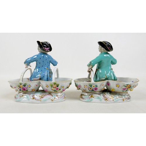 106 - A group of four 19th century Meissen salts, modelled as figures in 18th century attire sitting on tw... 