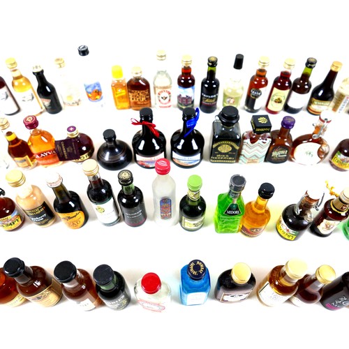 131 - A collection of sixty four spirit miniatures. (64)