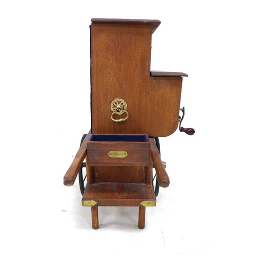 323 - A miniature Victorian style street musical organ grinder, with brass fittings, and extra musical dic... 