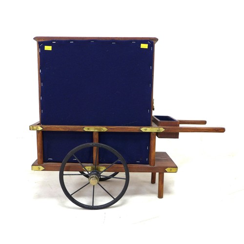 323 - A miniature Victorian style street musical organ grinder, with brass fittings, and extra musical dic... 