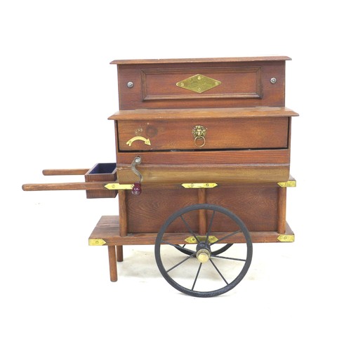 323 - A miniature Victorian style street musical organ grinder, with brass fittings, and extra musical dic... 