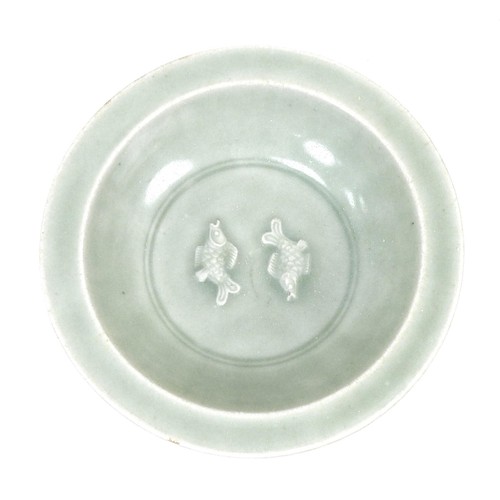 16 - A Chinese porcelain celadon dish, with lobed sides, with two underglaze relief carps to its centre, ... 