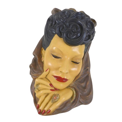 173 - An Art Deco style plaster wall mask, 24 by 37cm.