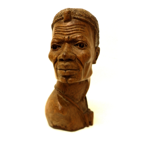 124 - An African carved bust, signed 'D. Kakweza', 23cm high.