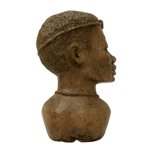 124 - An African carved bust, signed 'D. Kakweza', 23cm high.