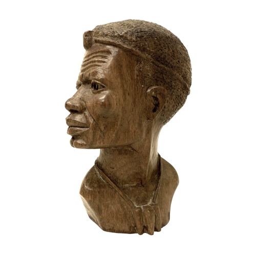 124 - An African carved bust, signed 'D. Kakweza', 23cm high.