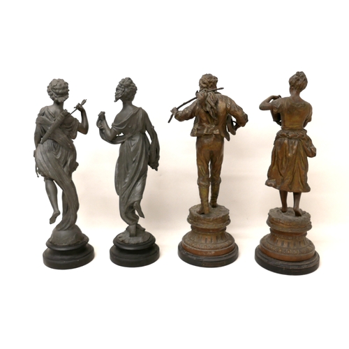 334 - Two pairs of spelter sculptures, modelled as standing figures, on circular bases, 44 and 46cm high. ... 