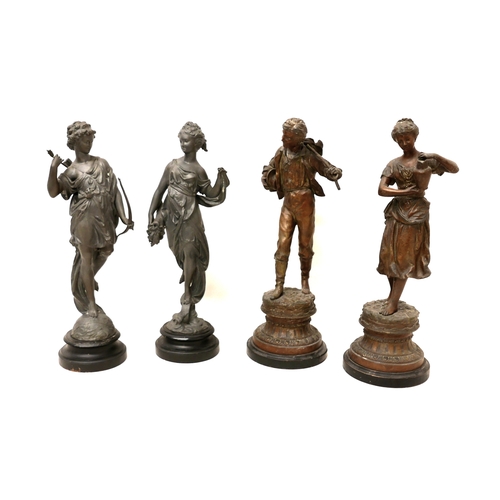 334 - Two pairs of spelter sculptures, modelled as standing figures, on circular bases, 44 and 46cm high. ... 