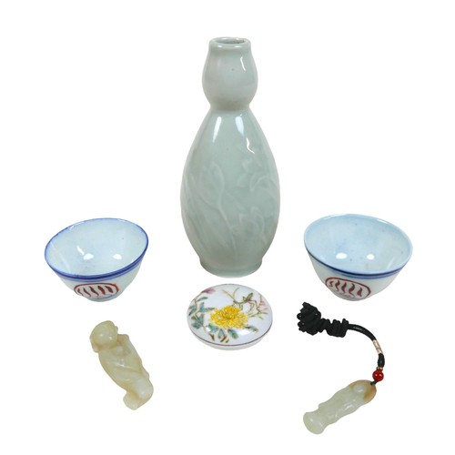 23 - A group of Oriental items to include two wine cups, a lidded pigment pot, a celadon vase and two soa... 