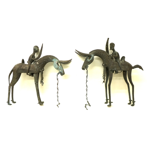 336 - A pair of bronze metal sculptures, Nigerian, mid 20th century, modelled as mounted horsemen with swo... 