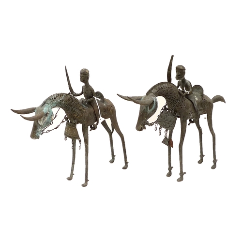 336 - A pair of bronze metal sculptures, Nigerian, mid 20th century, modelled as mounted horsemen with swo... 