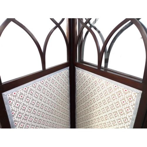 515 - An Edwardian mahogany room screen, the three panels with astragal glazed uppers and fabric panels be... 