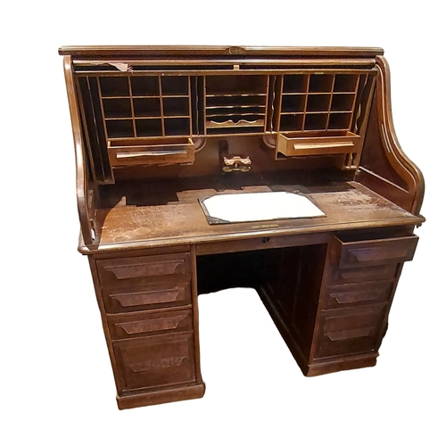 546 - An Edwardian oak roll top desk by Cutler, with fitted interior including pen and ink well holder, pi... 