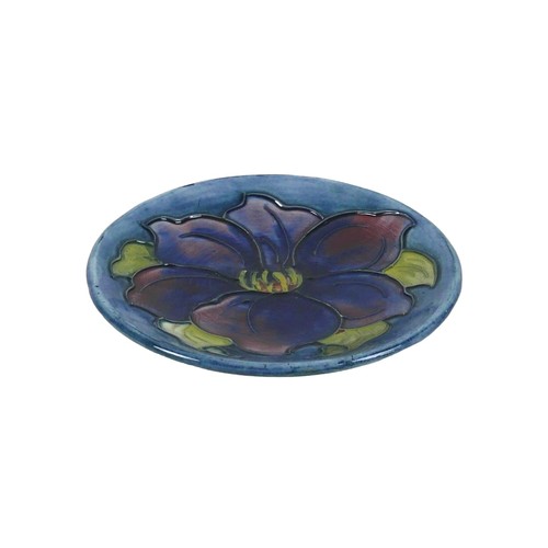 37 - A Moorcroft pin dish, circa 1940, tube lined with a blue anemone, impressed factory mark and origina... 