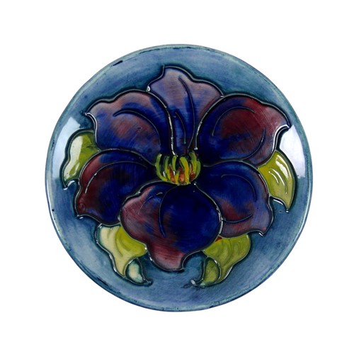 37 - A Moorcroft pin dish, circa 1940, tube lined with a blue anemone, impressed factory mark and origina... 