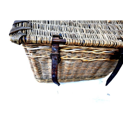 310 - A vintage wicker hamper, with brown leather straps, 65 by 44 by 39cm high.