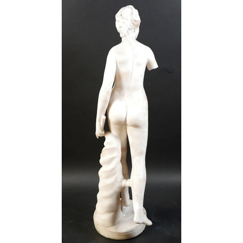 128 - A white marble statue, modelled as a Greek or Roman Goddess, standing nude on her left foot, 15 by 2... 