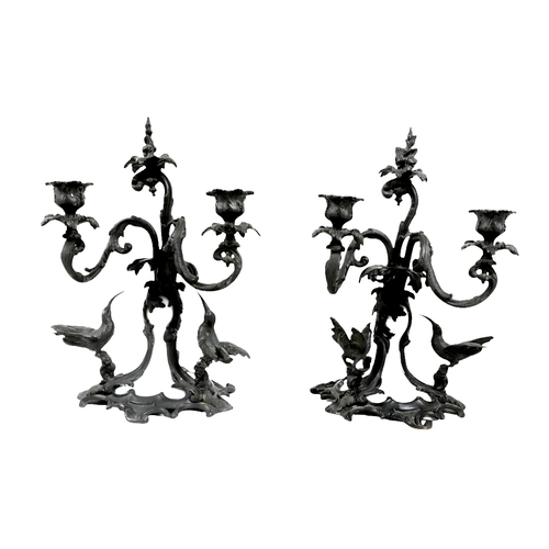 56 - A pair of bronze and milk glass twin branch candlesticks, possibly French 19th century, each with sc... 