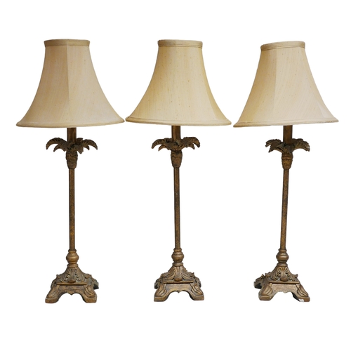 349 - A group of three table lamps with palm tree bases, cream shades, each 27 by 70 cm high. (3)