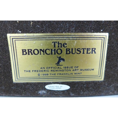 125 - A Franklin Mint bronze resin sculpture, 'Broncho Buster', after Frederic Remington, 16 by 5 by 17cm ... 