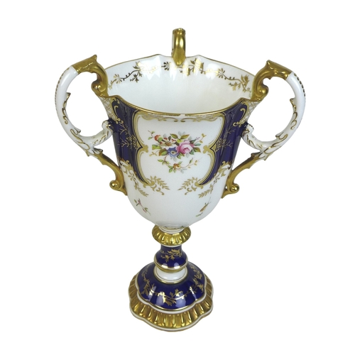 86 - An Edwardian Coalport porcelain goblet-vase, shape 144, modelled with three handles, flared rim, on ... 