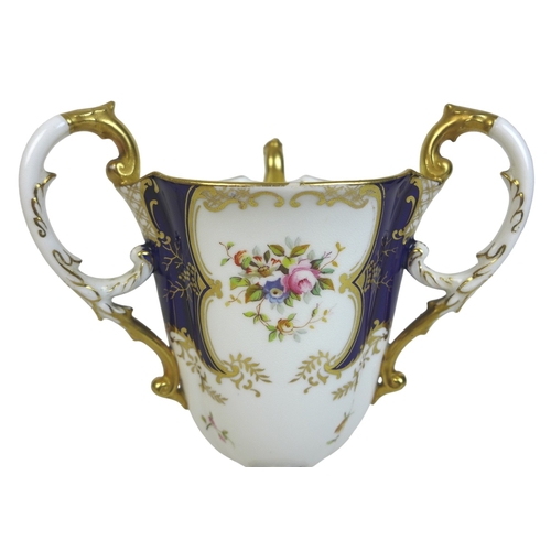 86 - An Edwardian Coalport porcelain goblet-vase, shape 144, modelled with three handles, flared rim, on ... 