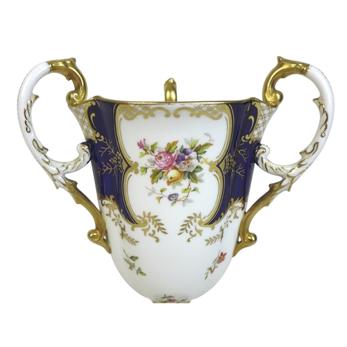 86 - An Edwardian Coalport porcelain goblet-vase, shape 144, modelled with three handles, flared rim, on ... 