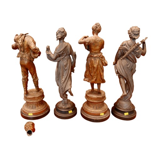 334 - Two pairs of spelter sculptures, modelled as standing figures, on circular bases, 44 and 46cm high. ... 