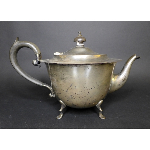 72 - An Edwardian silver three piece tea set, comprising milk jug, teapot with ebonized wooden handle and... 