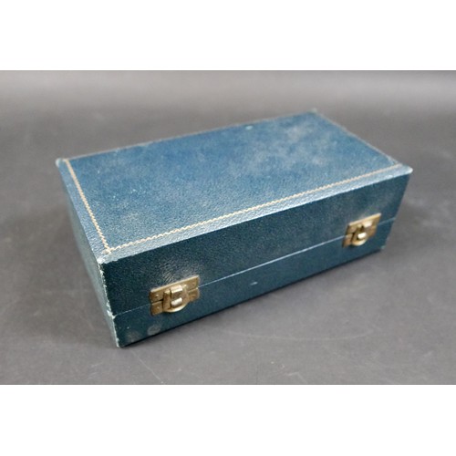 34 - An ERII cased silver cruet set, comprising a salt and mustard pot both with blue glass liners, a pep... 
