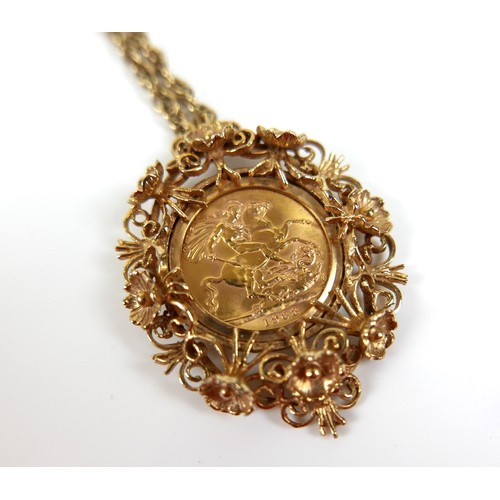 105 - An Elizabeth II gold sovereign, 1963, mounted in a 9ct gold ornate floral and scrolling pendant moun... 