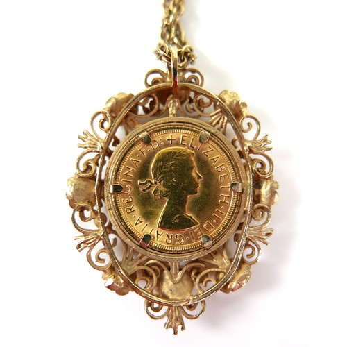 105 - An Elizabeth II gold sovereign, 1963, mounted in a 9ct gold ornate floral and scrolling pendant moun... 