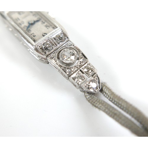 146 - An Art Deco Eszeha platinum and diamond set lady's cocktail wristwatch, the rectangular silvered dia... 