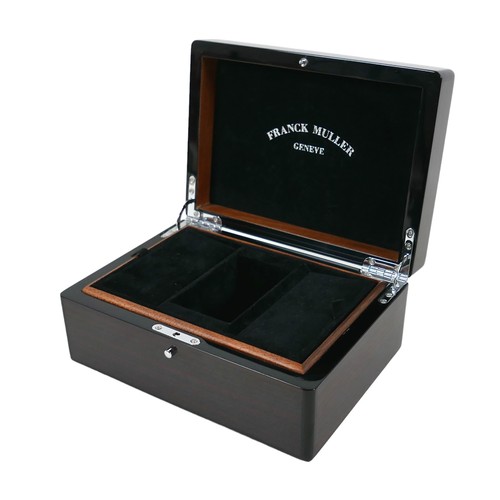 120 - An exotic wood watch box, branded for 'Franck Muller, Geneve', with fitted interior and chromed meta... 