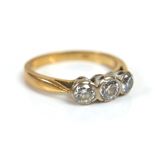 328 - An 18ct three stone diamond ring, central stone approximately 4mm, flanked by 3mm diameter stones, s... 