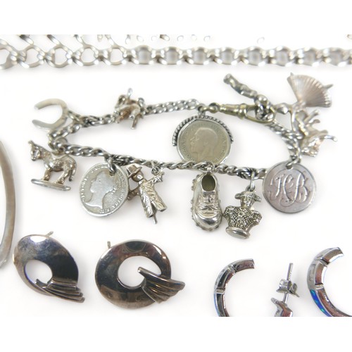 209 - A silver charm bracelet, two silver bangles and other assorted silver and white metal jewellery tota... 