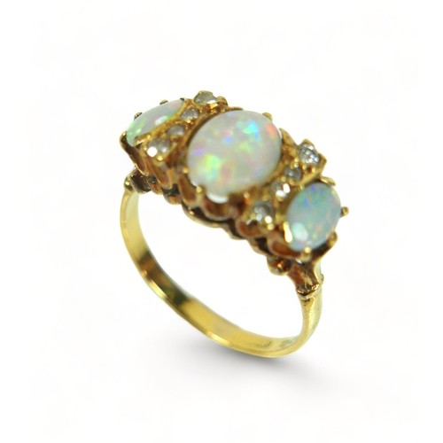 258 - A hallmarked 18ct yellow gold opal and diamond ring, the central stone 8mm by 5mm, ring size P, 4.4 ... 