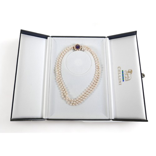 337 - A good quality triple string of pearls with a hallmarked amethyst set yellow gold clasp, 38cm long, ... 