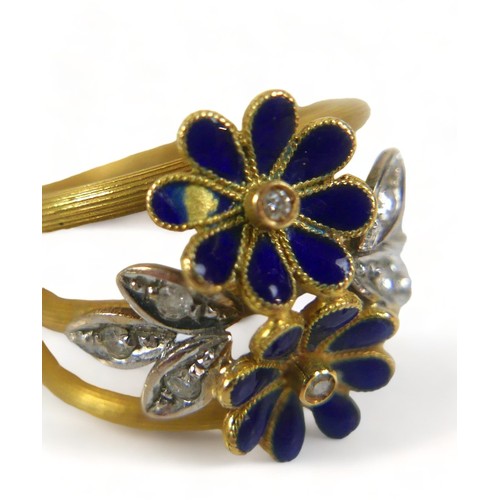 317 - A diamond and enamel flower head ring, with eight small diamonds, the band stamped '750', size M, 7.... 