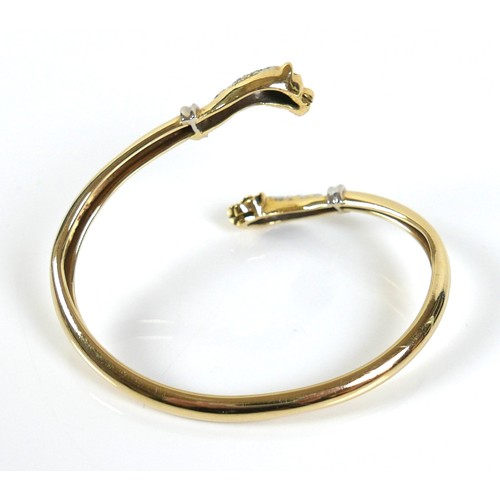 322 - A yellow gold open torc style bangle, formed with a panther's head at each end, set with small diamo... 