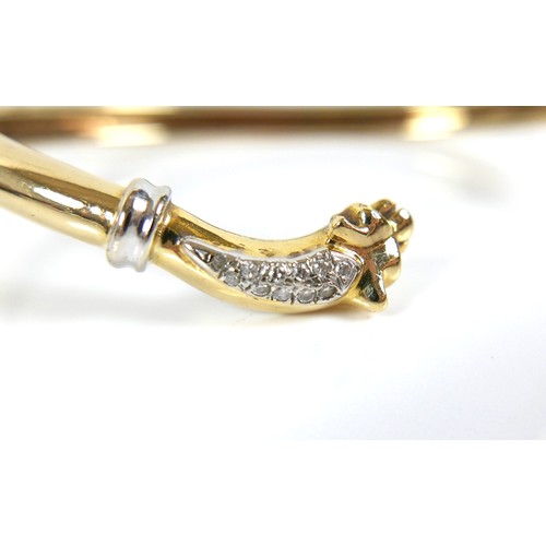 322 - A yellow gold open torc style bangle, formed with a panther's head at each end, set with small diamo... 