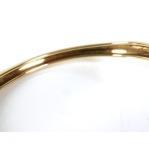 322 - A yellow gold open torc style bangle, formed with a panther's head at each end, set with small diamo... 