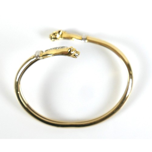 322 - A yellow gold open torc style bangle, formed with a panther's head at each end, set with small diamo... 