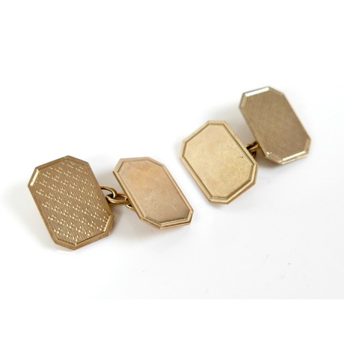 200 - A pair of vintage 9ct gold cufflinks, of canted rectangular form with engraved decoration, chain lin... 