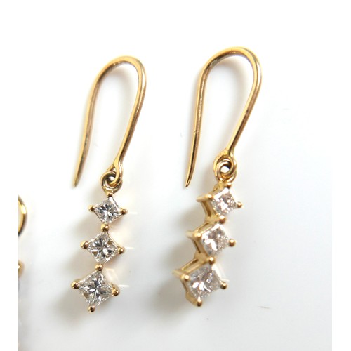 306 - Two pairs of 18ct gold drop earrings, one pair each set with three graduating princess cut diamonds,... 