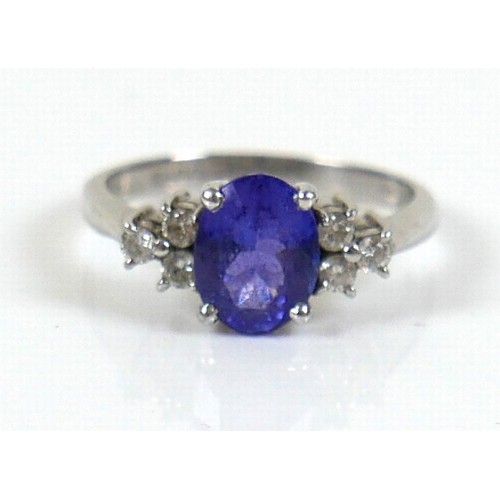 298 - An 18ct white gold Tanzanite and diamond ring, the oval cut tanzanite, by David Tinsley, approximate... 