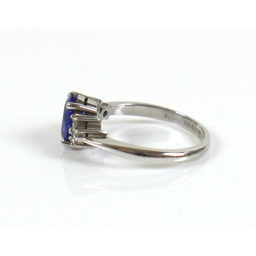 298 - An 18ct white gold Tanzanite and diamond ring, the oval cut tanzanite, by David Tinsley, approximate... 