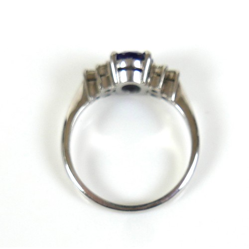 298 - An 18ct white gold Tanzanite and diamond ring, the oval cut tanzanite, by David Tinsley, approximate... 